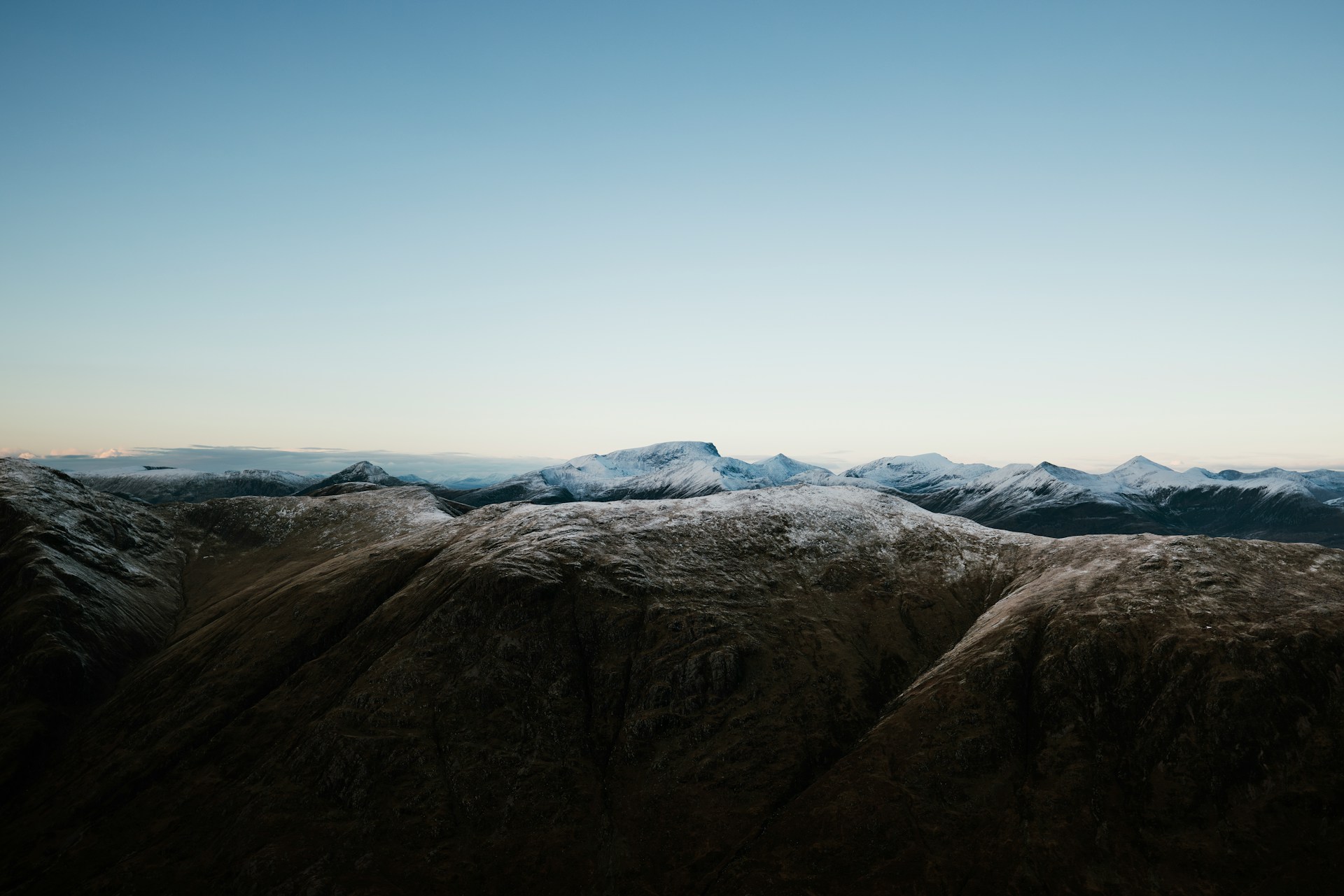 Snow-dusted ridgelines under a clear sky